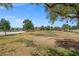 View of the neighborhood park with lush trees, a playground, and expansive green space for community activities at 8100 Artistic Heights Ct, Las Vegas, NV 89143