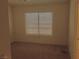 Spacious bedroom with a large window and carpet flooring, providing a comfortable and relaxing environment at 8501 Stan Crest Dr, Las Vegas, NV 89134
