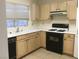 Functional kitchen design with wooden cabinets, tile floor, and black appliances at 8501 Stan Crest Dr, Las Vegas, NV 89134