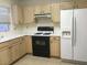 Well-lit kitchen features wooden cabinets, essential appliances, and tile flooring at 8501 Stan Crest Dr, Las Vegas, NV 89134
