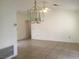 Bright living room features neutral walls, decorative chandelier and durable tile flooring at 8501 Stan Crest Dr, Las Vegas, NV 89134