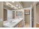 Bathroom featuring double sinks with large mirror and separate toilet and shower area at 897 Cavaison Ave, Las Vegas, NV 89123