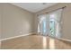 Bright bedroom with wood floors, neutral walls, and french doors leading to the outside at 897 Cavaison Ave, Las Vegas, NV 89123