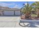 Charming single-Gathering home with a two-car garage, and desert landscaping with palm trees at 897 Cavaison Ave, Las Vegas, NV 89123