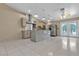 Spacious kitchen featuring stainless steel appliances, island and backsplash with ample cabinet space and tile floors at 897 Cavaison Ave, Las Vegas, NV 89123