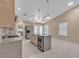 Bright, modern kitchen with stainless steel appliances, granite counters, and a large island with seating at 897 Cavaison Ave, Las Vegas, NV 89123