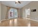 Bright living room with wood floors, ceiling fan, and french doors leading to an outdoor area at 897 Cavaison Ave, Las Vegas, NV 89123