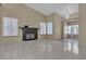 View of the living room with fireplace, tile flooring, decorative hanging light fixture, and shutters at 897 Cavaison Ave, Las Vegas, NV 89123