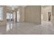 Spacious living room featuring tile floors, bright lighting, and decorative entryway in neutral color palette at 897 Cavaison Ave, Las Vegas, NV 89123