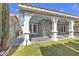 Inviting covered patio with tile flooring, stone accents, and access to the landscaped backyard at 897 Cavaison Ave, Las Vegas, NV 89123