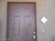 Close-up of a brown front door with address number in a neutral building exterior at 9000 Las Vegas Blvd # 2220, Las Vegas, NV 89123