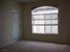 Bright living room featuring a large arched window and neutral carpeting at 9000 Las Vegas Blvd # 2220, Las Vegas, NV 89123