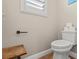 This half bath features a standard toilet and laminate floors at 9031 W Viking Rd, Las Vegas, NV 89147