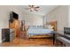Comfortable bedroom with wood floors, ceiling fan, and ample natural light at 9031 W Viking Rd, Las Vegas, NV 89147