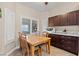 Charming dining area with wood table and natural light from shuttered windows at 9031 W Viking Rd, Las Vegas, NV 89147