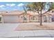 Charming home featuring a low-maintenance front yard, arched windows, and a two-car garage at 9031 W Viking Rd, Las Vegas, NV 89147