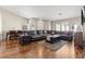 Comfortable living room featuring hardwood floors, neutral paint, and a large sectional sofa at 9031 W Viking Rd, Las Vegas, NV 89147
