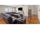 Comfortable living room featuring hardwood floors, neutral paint, and a large sectional sofa at 9031 W Viking Rd, Las Vegas, NV 89147
