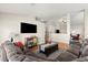 Comfortable living room featuring hardwood floors, neutral paint, and a large sectional sofa at 9031 W Viking Rd, Las Vegas, NV 89147