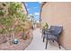 Cozy nook on a home's side yard featuring chairs and landscaping at 9031 W Viking Rd, Las Vegas, NV 89147