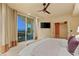 Spacious bedroom with balcony access, mounted TV and ensuite bathroom at 9101 Alta Dr # 1205, Las Vegas, NV 89145