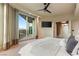 Well-lit bedroom with balcony access, ceiling fan, and a mounted television at 9101 Alta Dr # 1205, Las Vegas, NV 89145