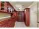 Elegant custom closet with extensive storage and rich wood finishes at 9101 Alta Dr # 1205, Las Vegas, NV 89145