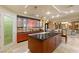 Spacious kitchen featuring an island, bar seating, marble floors, and wood cabinets at 9101 Alta Dr # 1205, Las Vegas, NV 89145