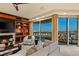 Comfortable living room featuring a fireplace, built-in shelves, and a balcony with expansive city views at 9101 Alta Dr # 1205, Las Vegas, NV 89145