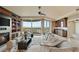 Bright living room with a fireplace, built in shelving, and sliding glass doors to a balcony at 9101 Alta Dr # 1205, Las Vegas, NV 89145