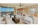 Living room featuring a wet bar, plush seating, and city views from the sliding glass doors at 9101 Alta Dr # 1205, Las Vegas, NV 89145