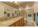 Bathroom featuring double sinks with granite countertops and a shower-tub combo, offering convenience and style at 9909 Barrier Reef Dr, Las Vegas, NV 89117