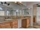 A bathroom with a double sink vanity, granite countertops, and ample storage at 9909 Barrier Reef Dr, Las Vegas, NV 89117