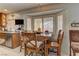A charming breakfast nook with a bay window, a wood table and chairs, and ample natural light at 9909 Barrier Reef Dr, Las Vegas, NV 89117
