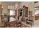 Traditional dining room with a chandelier, wooden furniture, and ample natural light creating an inviting atmosphere at 9909 Barrier Reef Dr, Las Vegas, NV 89117