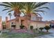 Lovely home with mature palm trees and lush landscaping enhancing its curb appeal and charm at 9909 Barrier Reef Dr, Las Vegas, NV 89117