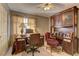 An elegant home office with custom built-ins, two desks, and comfortable seating at 9909 Barrier Reef Dr, Las Vegas, NV 89117