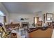 Elegant living room featuring classic furnishings, a fireplace, and natural light streaming through the windows at 9909 Barrier Reef Dr, Las Vegas, NV 89117