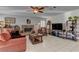 Comfortable living room featuring a sofa, fireplace, and display shelves for a cozy and inviting atmosphere at 9909 Barrier Reef Dr, Las Vegas, NV 89117