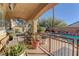 Covered patio with potted plants and wrought iron railings, perfect for outdoor dining and entertaining at 9909 Barrier Reef Dr, Las Vegas, NV 89117