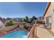 A backyard pool with a hot tub, a deck, and mountain views at 9909 Barrier Reef Dr, Las Vegas, NV 89117