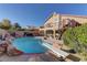 Backyard pool area featuring a diving board, rock accents, and a spiral staircase, creating an oasis at 9909 Barrier Reef Dr, Las Vegas, NV 89117