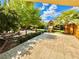 Serene backyard featuring mature landscaping, stone patio, and a charming playset, perfect for relaxation at , Las Vegas, NV 89121