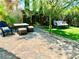 Outdoor living space featuring brick patio with a table, chairs, and manicured landscaping at , Las Vegas, NV 89121