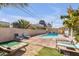 Relaxing backyard with pool, lounge chairs, and manicured landscaping at , Las Vegas, NV 89121