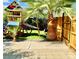 Backyard view with a ' playset, hammock, mature trees, and gated access to the side yard at , Las Vegas, NV 89121