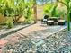 Landscaped backyard features a stone patio with table, chairs, and surrounding rock features at , Las Vegas, NV 89121