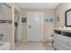 Well-lit bathroom showcasing a vanity, commode, door, and a tiled shower/bathtub combo at , Las Vegas, NV 89121