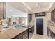 This eat-in kitchen boasts granite counters, stainless appliances, a tile backsplash, and dark wood cabinetry at , Las Vegas, NV 89121