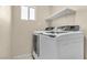 Laundry room with modern white appliances and overhead shelving at , Las Vegas, NV 89121